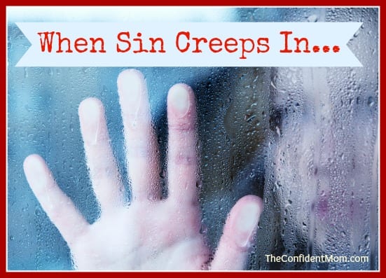 hand of young woman melancholy and sad at the window in the rain